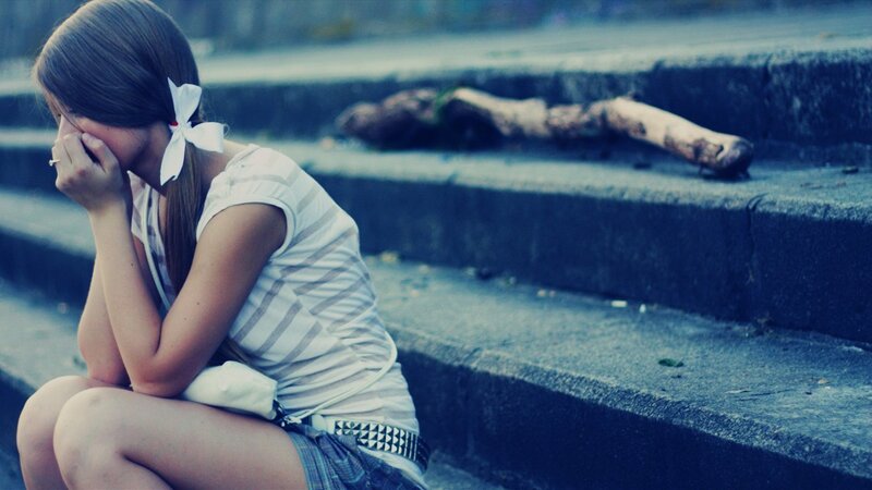 sad girl sitting on steps