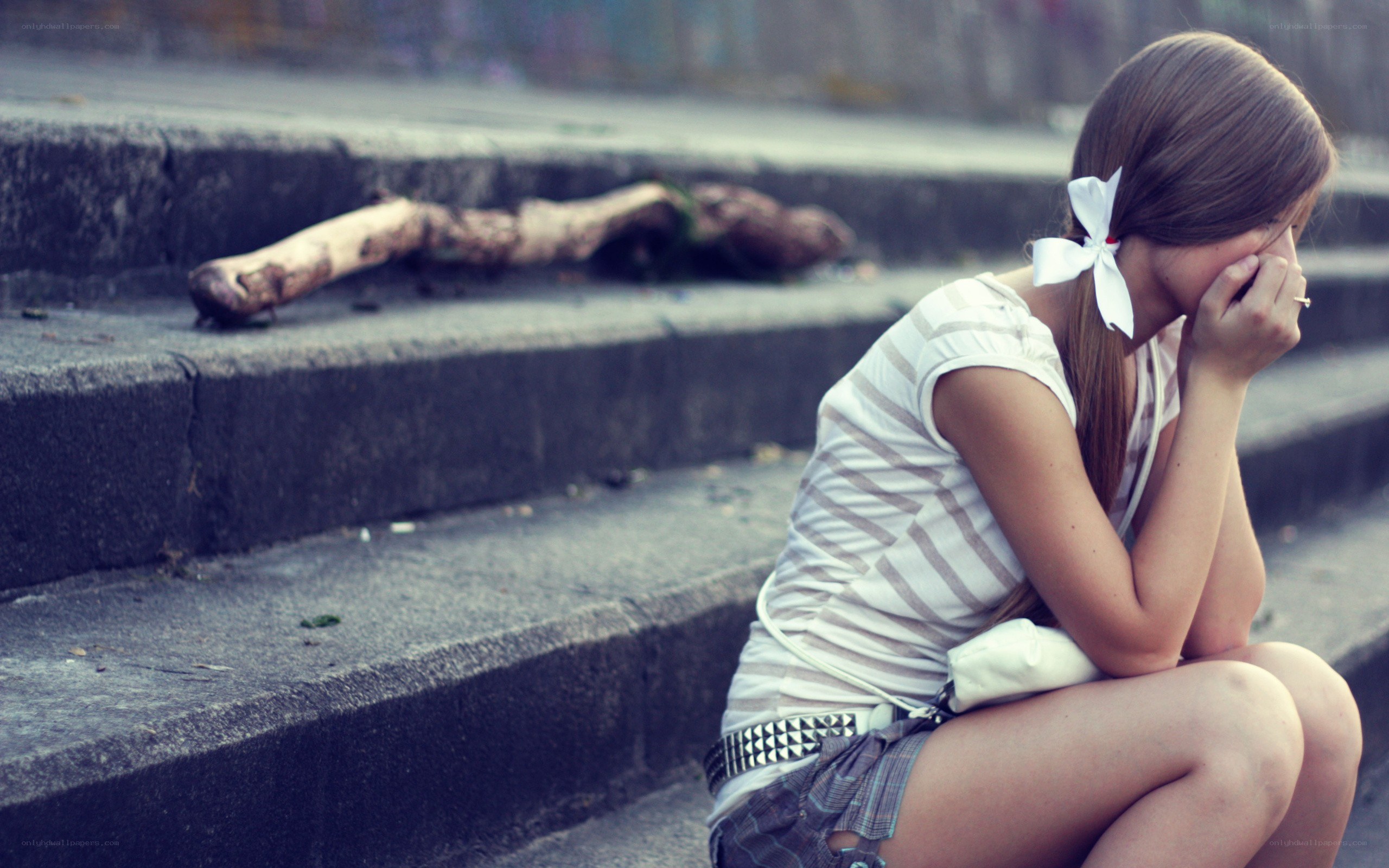 sad girl sitting on steps