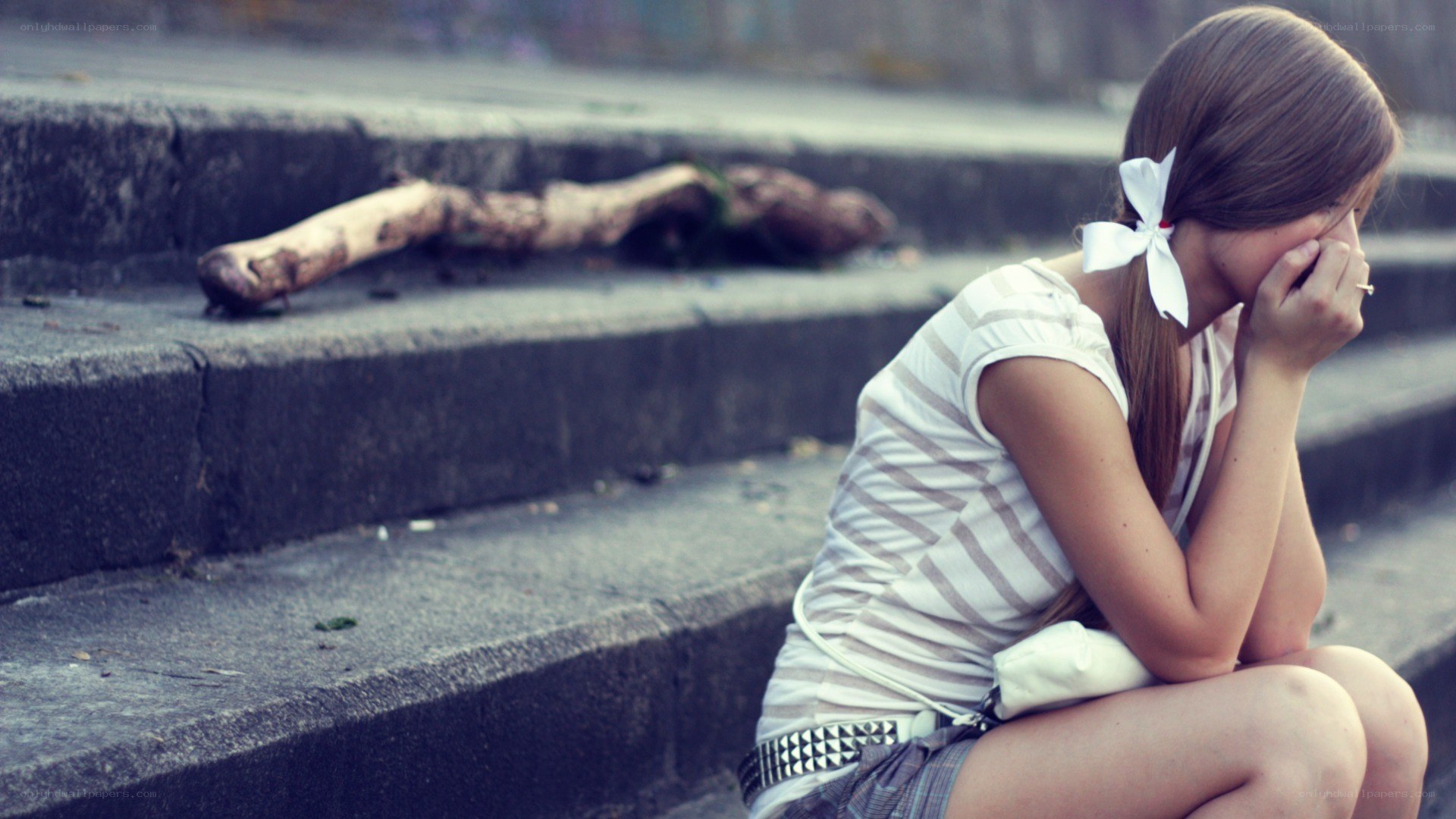 sad girl sitting on steps