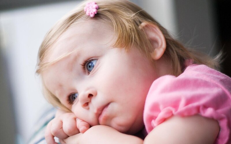 sad little girl with blue eyes