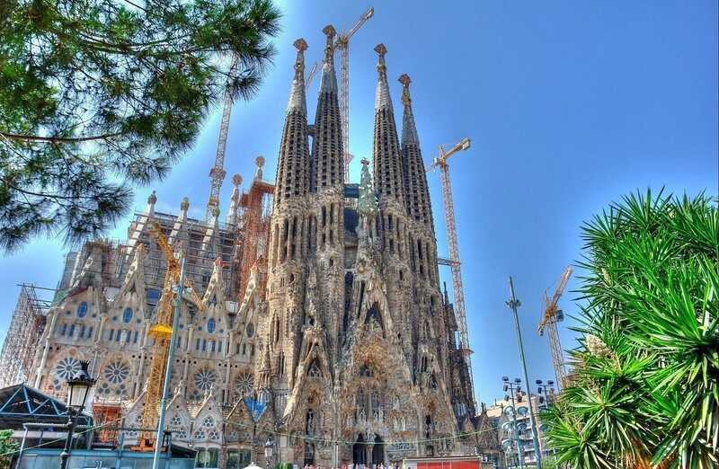 Sagrada Familia Cathedral — Blue, Dramatic, Afternoon, Photograph, Cranes, Trees, Scaffolding, Sky, Green