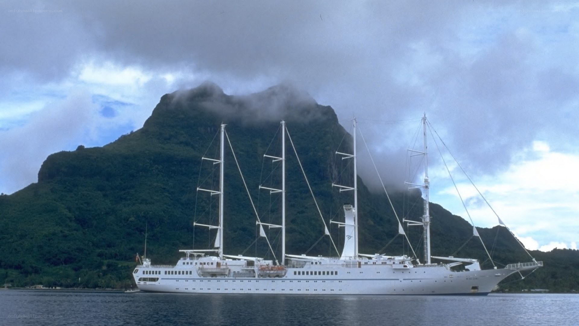 Sail ship near mountain