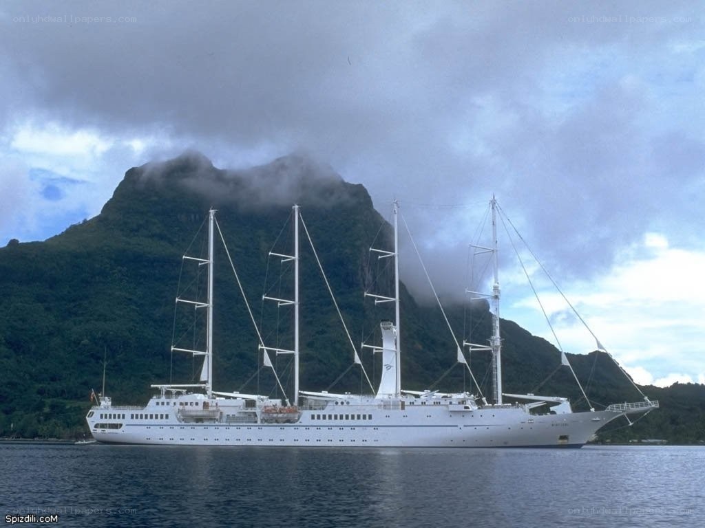 Sail ship near mountain