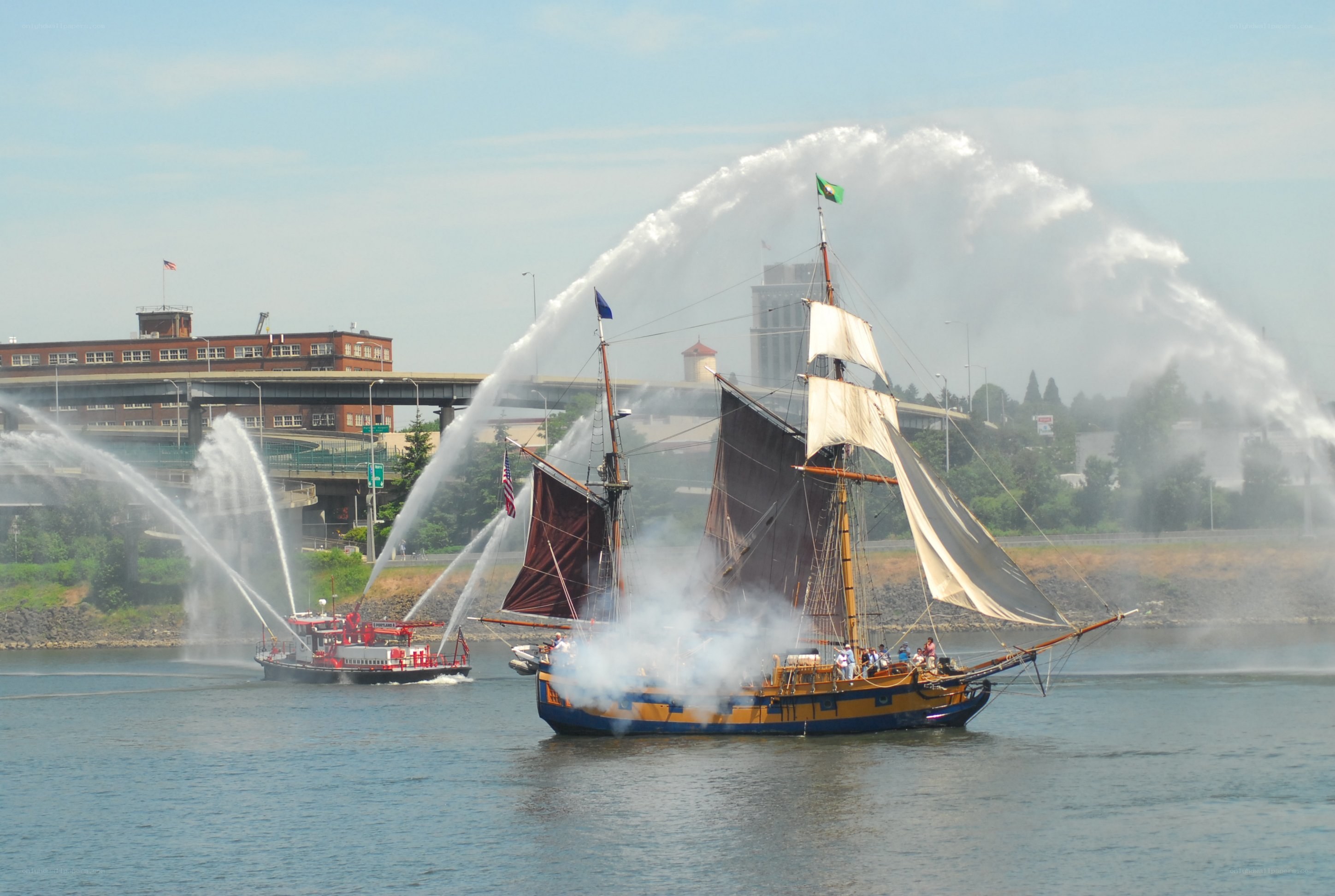 Sailboat and fireboat on river