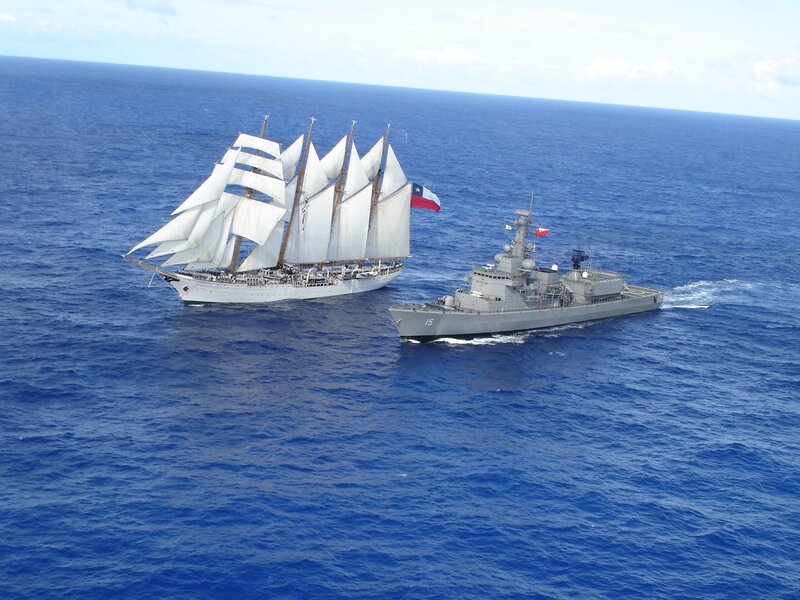 Sailboat and warship at sea