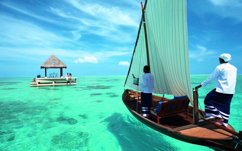 Sailboat Approaching Overwater Bungalow