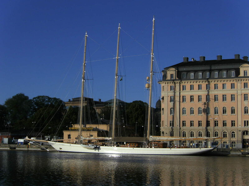 Sailboat at a city harbor