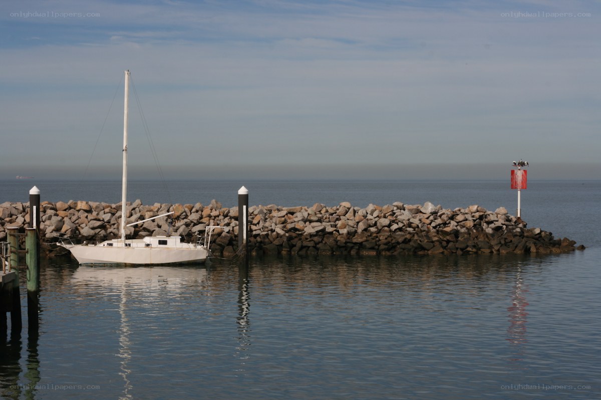 Sailboat at a rocky pier
