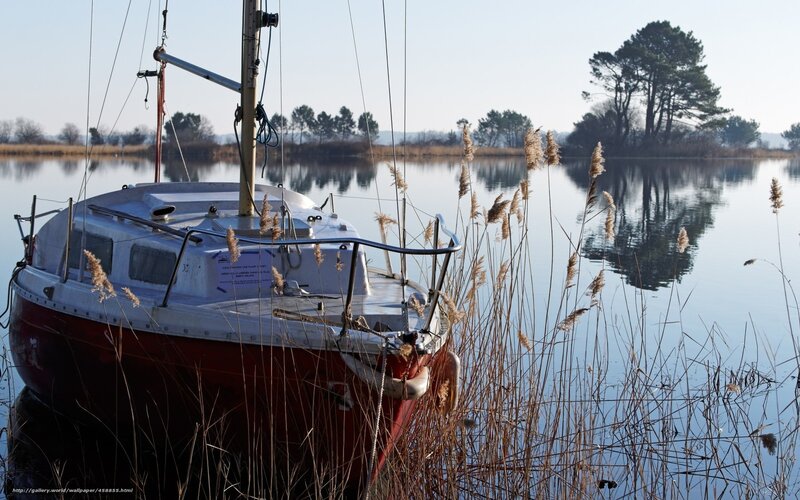 sailboat at dawn on a calm lake