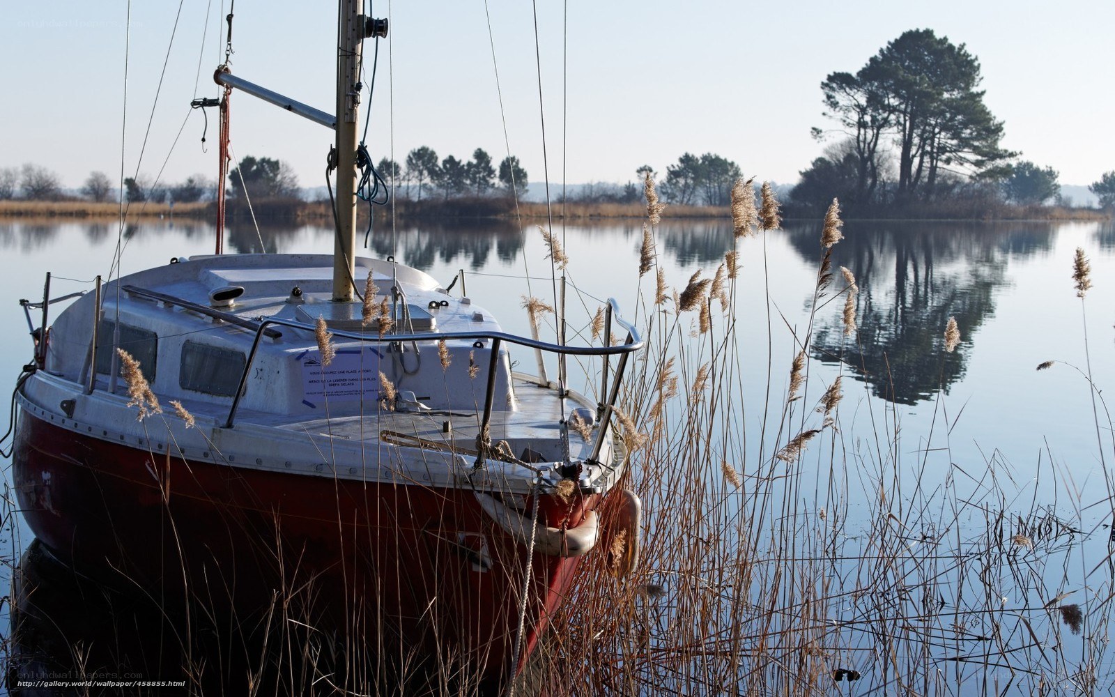 sailboat at dawn on a calm lake