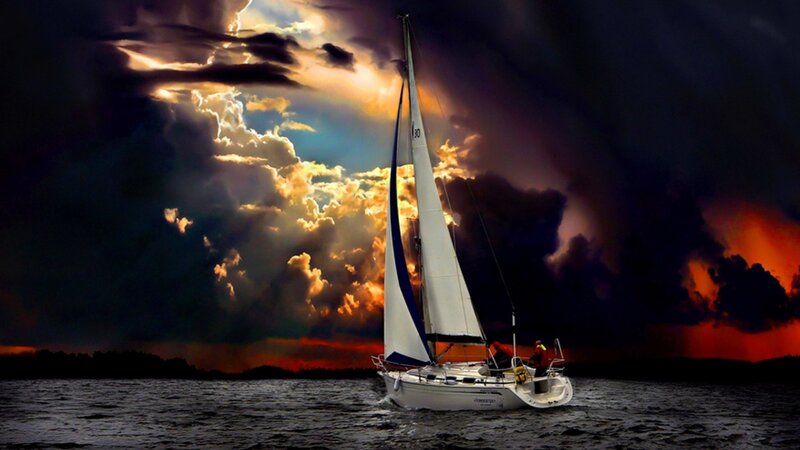 Sailboat at dramatic sunset