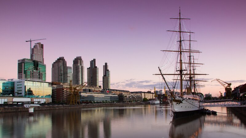 sailboat at dusk in city