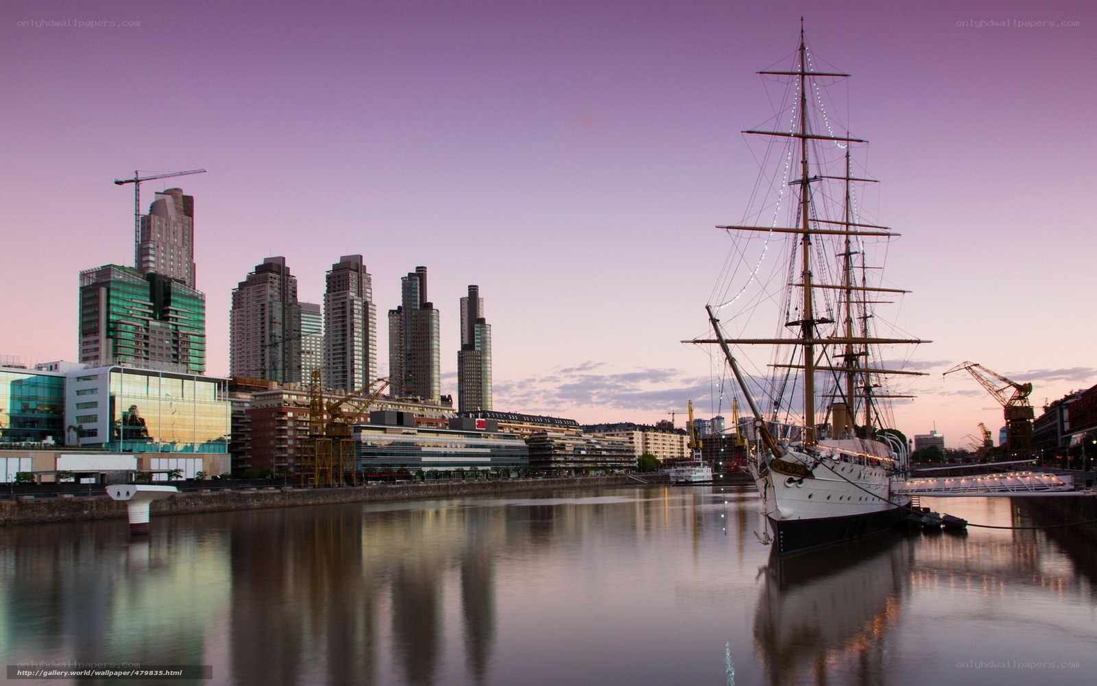sailboat at dusk in city