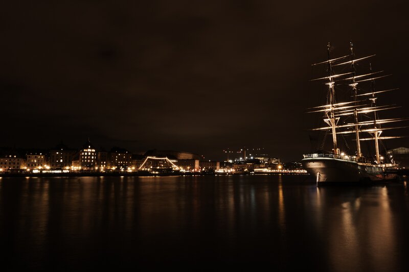 Sailboat at Night — Black, Serene, Photograph, City Skyline, Bridge