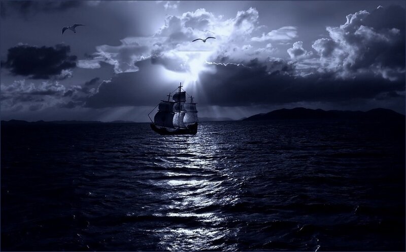 sailboat at night under moonlight