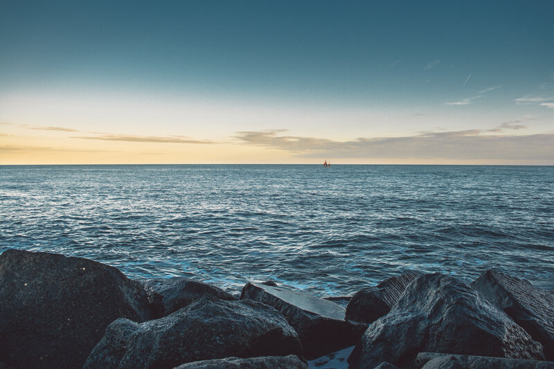 sailboat at sea during sunset