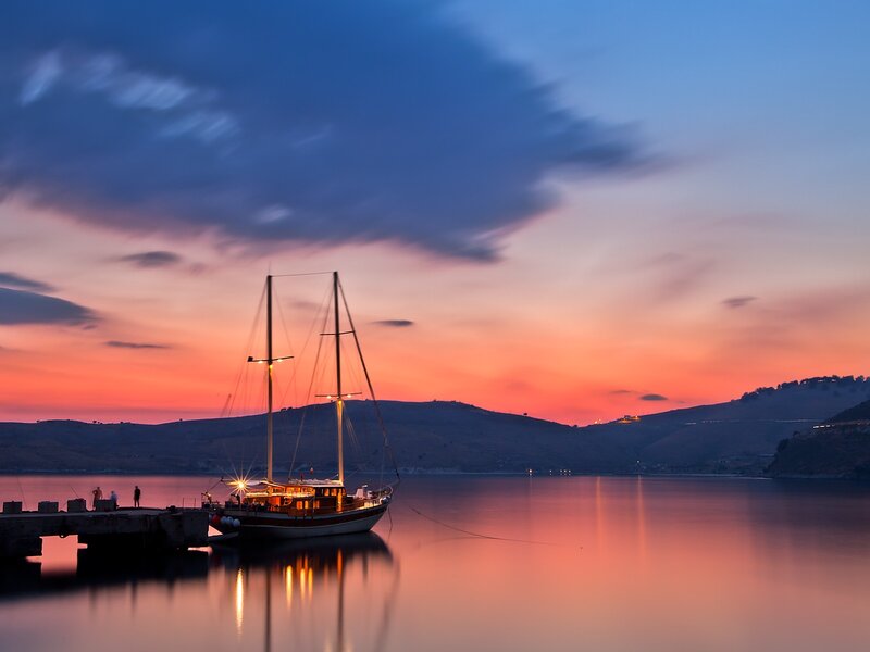 Sailboat at sunset by the coast