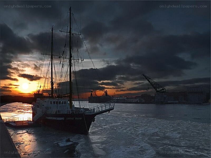 sailboat at sunset in a harbor