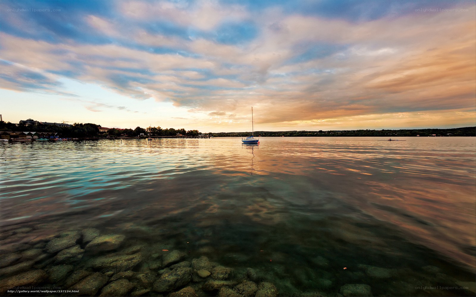 Sailboat at sunset on a calm lake