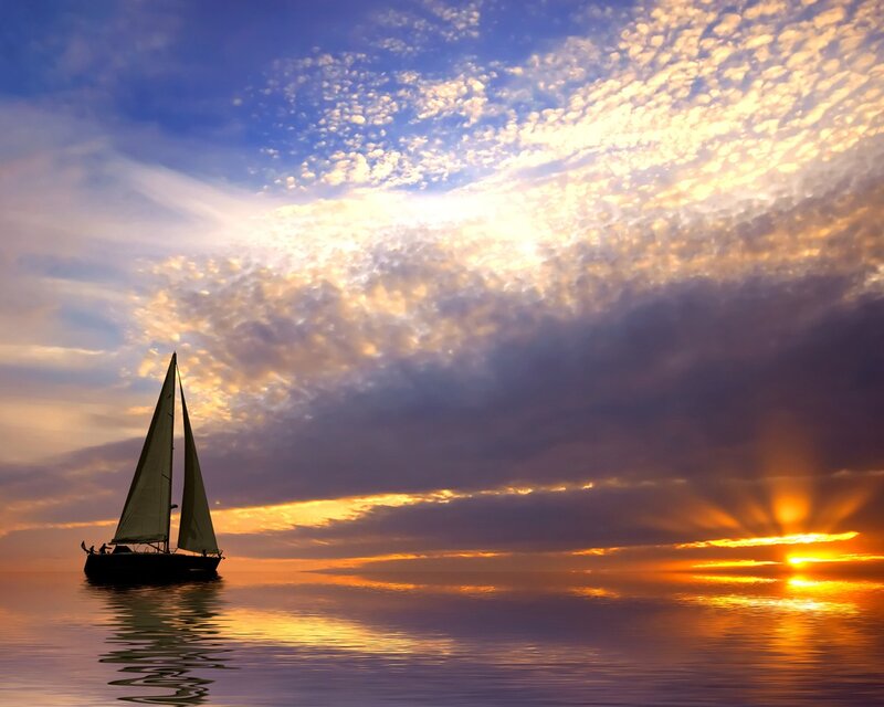 Sailboat at sunset on calm sea