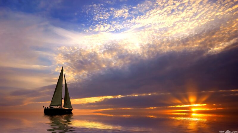 sailboat at sunset on calm sea