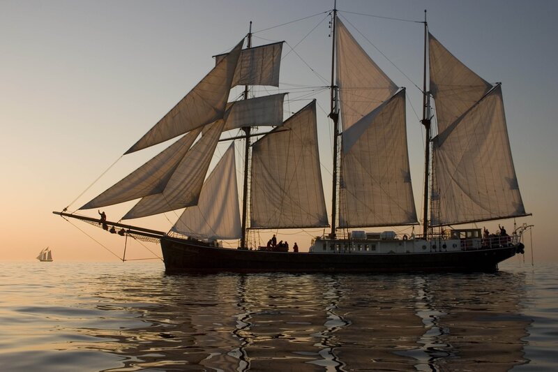 Sailboat at sunset on calm sea
