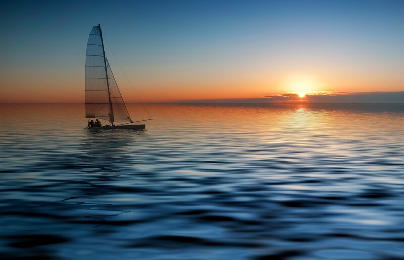 Sailboat at sunset on calm sea