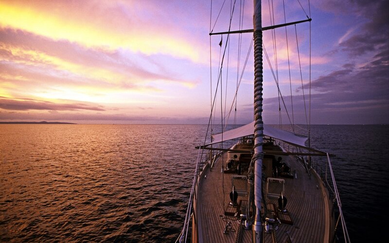 Sailboat at sunset on calm sea