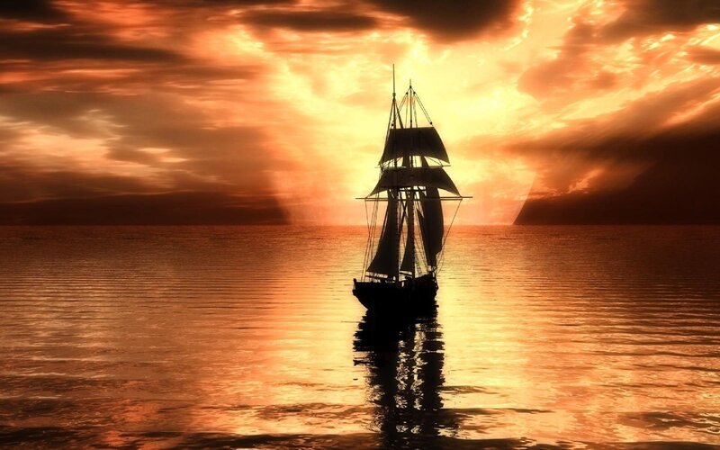 sailboat at sunset on calm sea