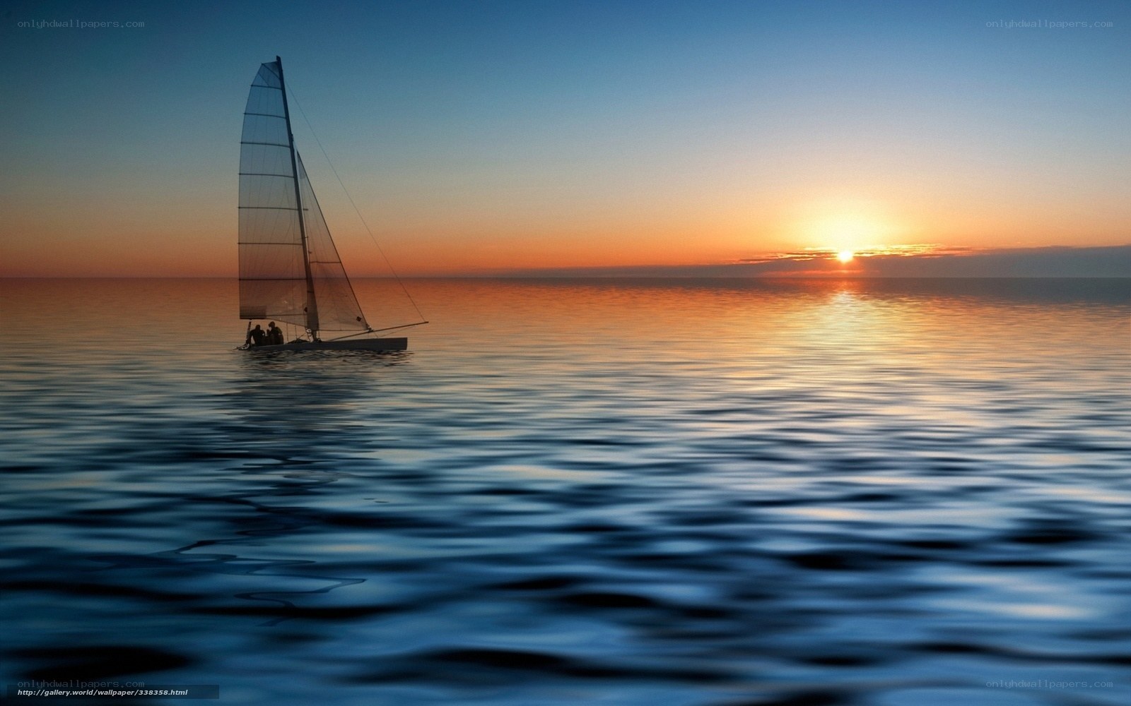 Sailboat at sunset on calm sea
