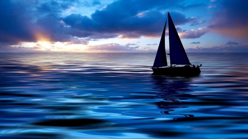 sailboat at sunset on calm sea