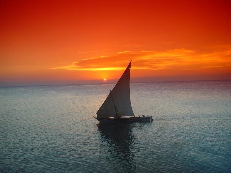Sailboat at sunset on calm sea