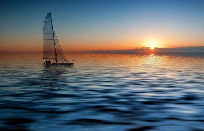 Sailboat at sunset on calm sea