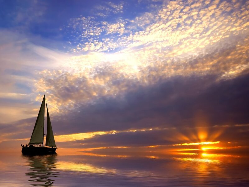 Sailboat at sunset on calm sea