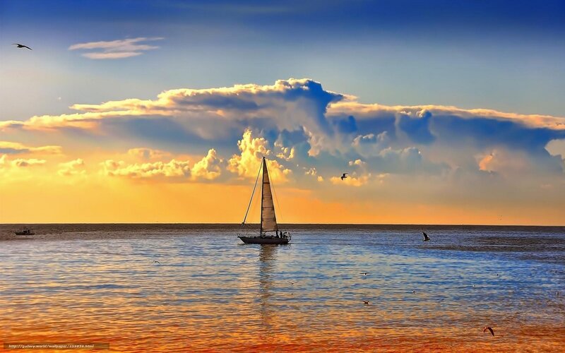 Sailboat at sunset on calm sea