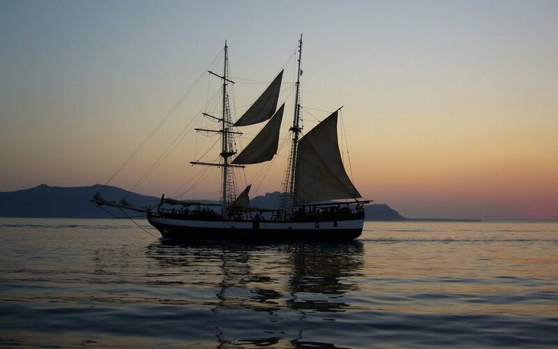 sailboat at sunset on calm sea