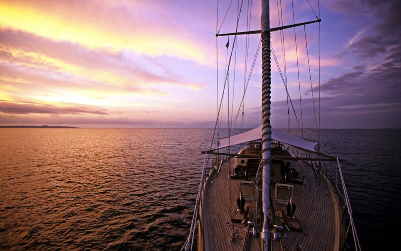 Sailboat at sunset on calm sea