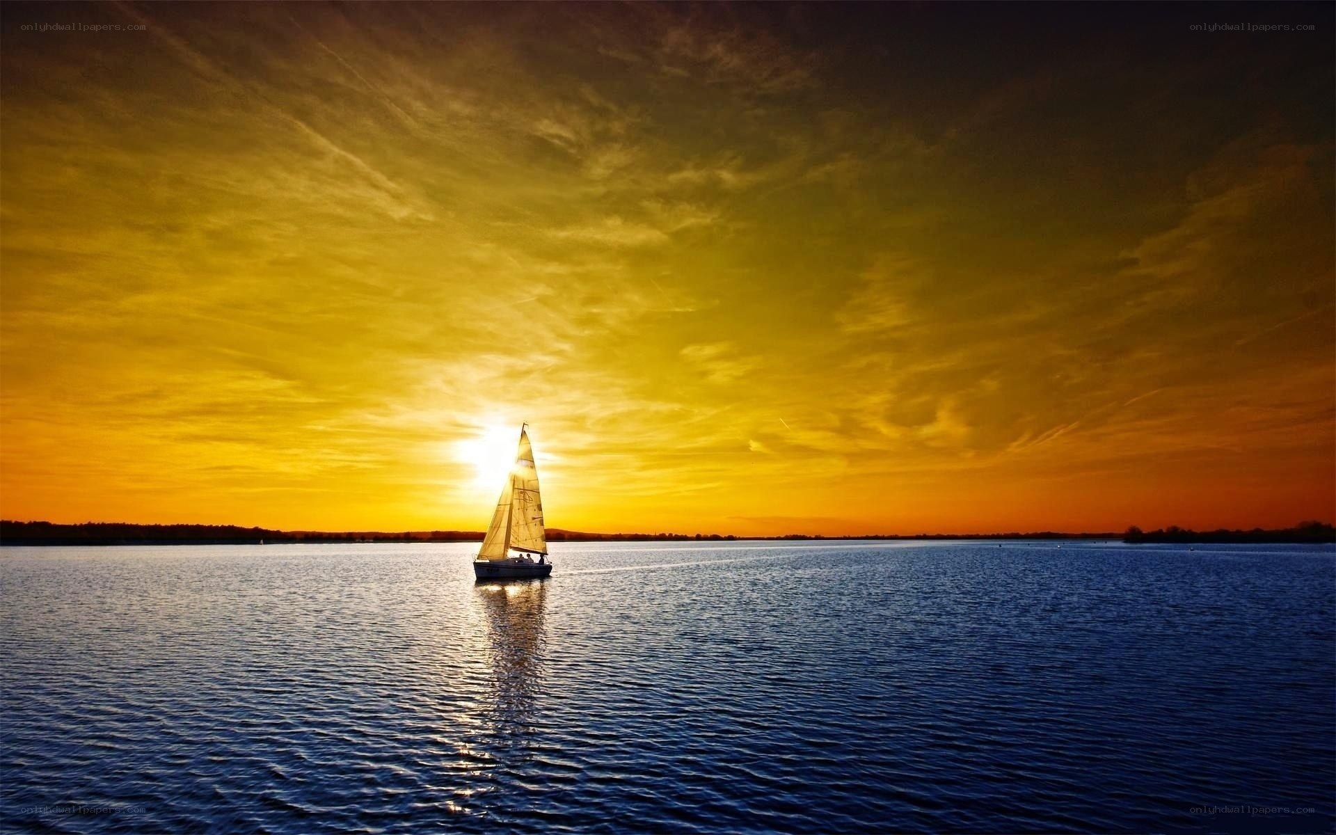 Sailboat at sunset on calm water