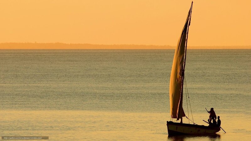 Sailboat at sunset on calm water