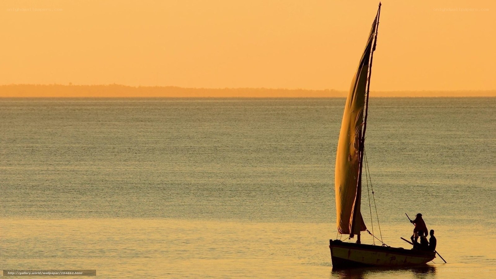 Sailboat at sunset on calm water