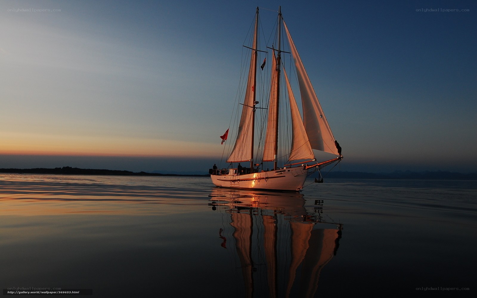 Sailboat at sunset on calm water