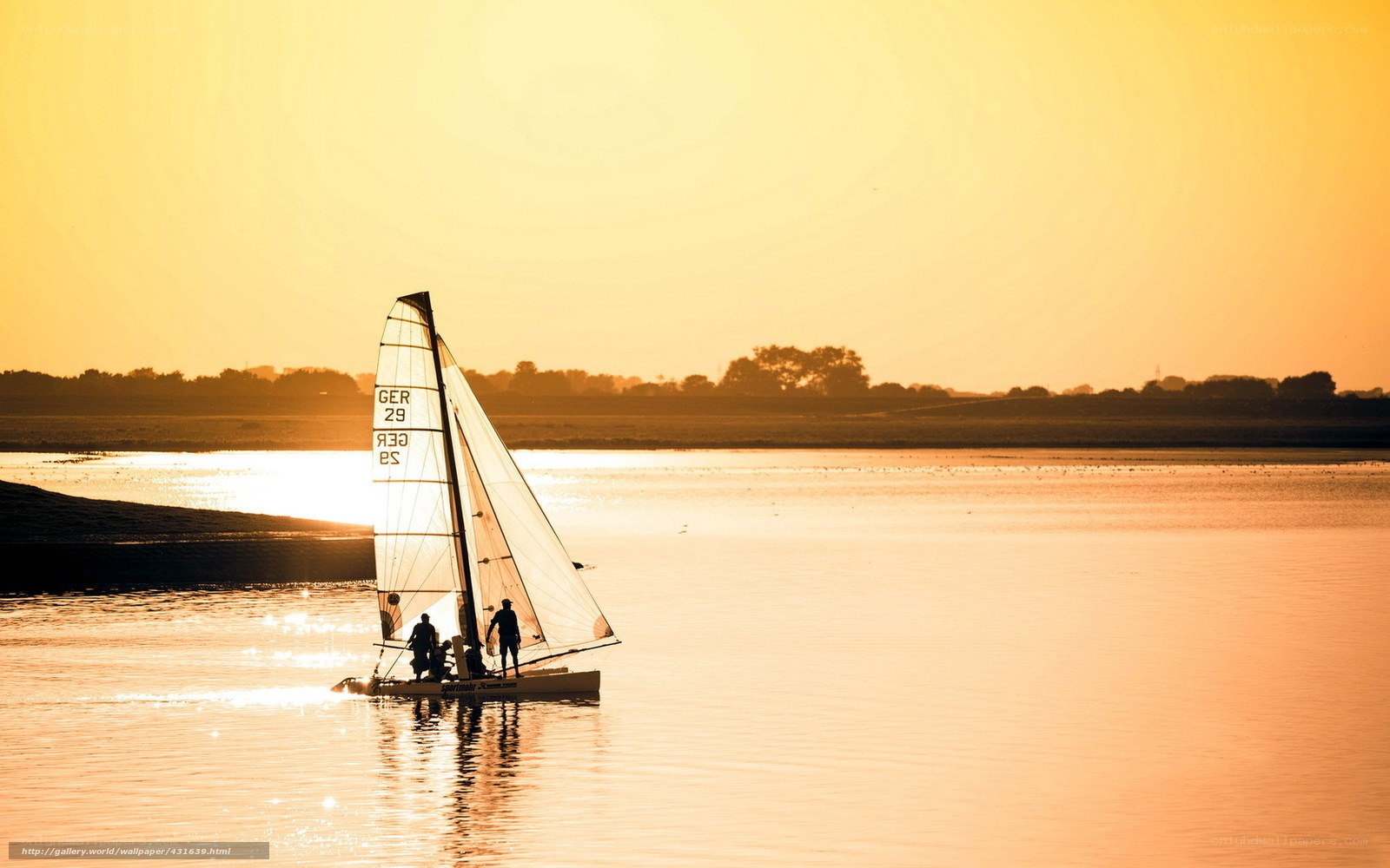Sailboat at sunset on calm water