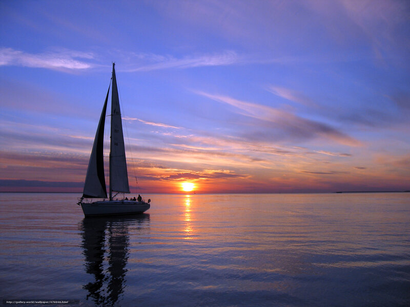 Sailboat at sunset on calm water