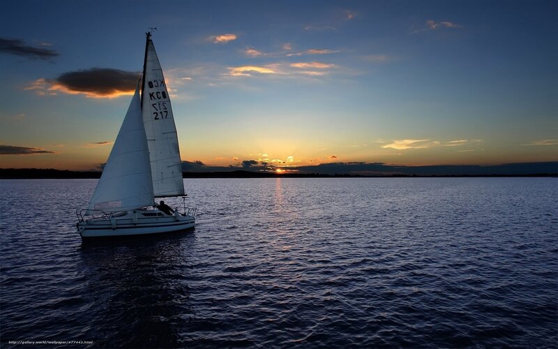Sailboat at sunset on calm water