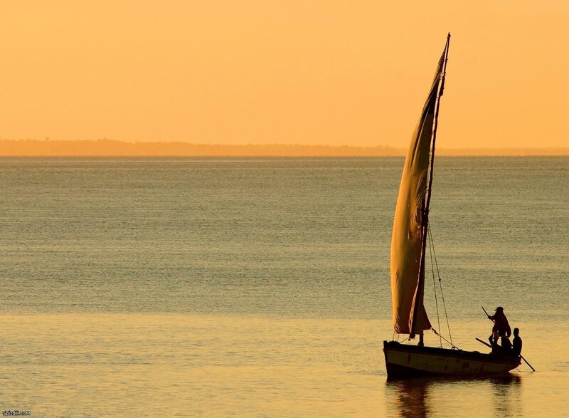 Sailboat at sunset on calm water