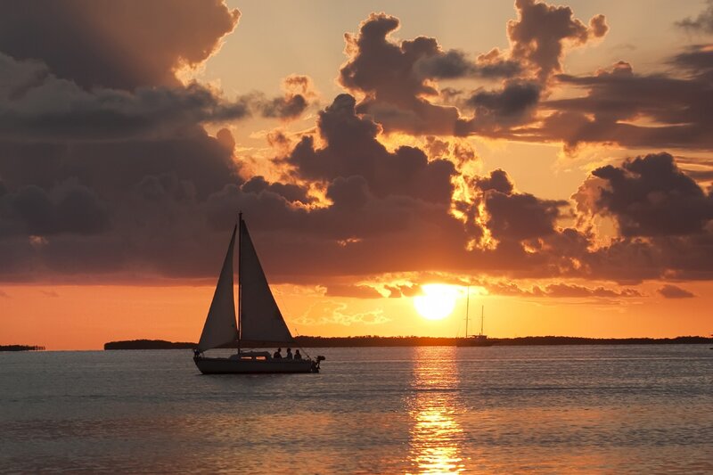 Sailboat at sunset on calm water