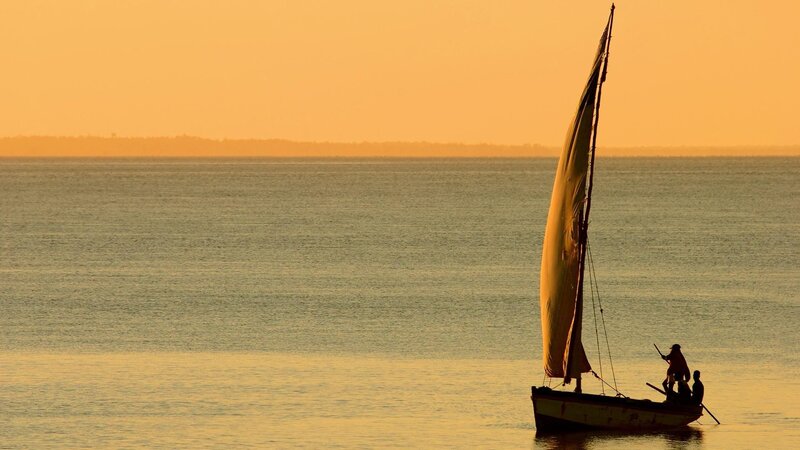 sailboat at sunset on calm water