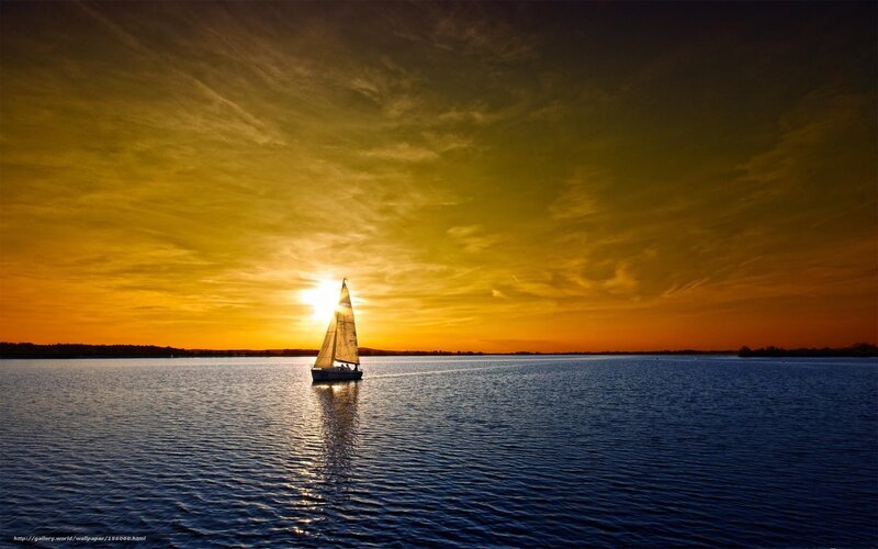 sailboat at sunset on calm water