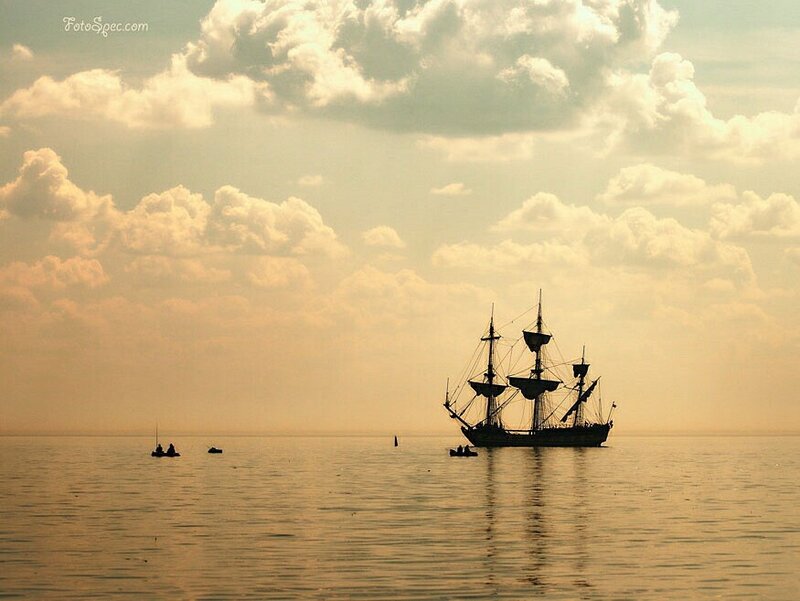 sailboat at sunset on calm water