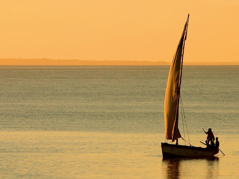Sailboat at sunset on calm water